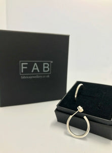 Solid Sterling Silver hoop 2mm earrings alongside black jewellery box.