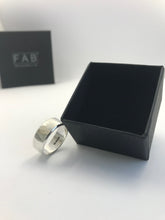 Load image into Gallery viewer, Solo Men&#39;s Handmade Textured Sterling Silver Ring Leaning Against Black FAB Jewellery Box.