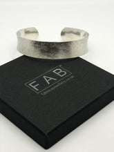 Load image into Gallery viewer, 925 Sterling Silver Textile Texture Cuff Bracelet Resting On Corner Of Jewellery Box.