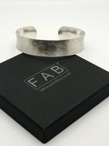 925 Sterling Silver Textile Texture Cuff Bracelet Resting On Corner Of Jewellery Box.