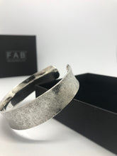 Load image into Gallery viewer, 925 Sterling Silver Textile Texture Cuff Bracelet Resting On Front Corner Of Jewellery Box With FAB Logo In Background.