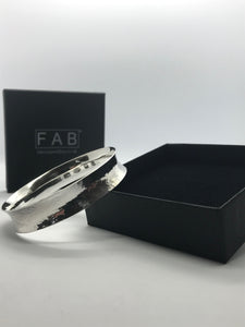 925 Sterling Silver Planished Texture Anticlastic Bracelet Leaning On Black Eco Friendly Jewellery Box.