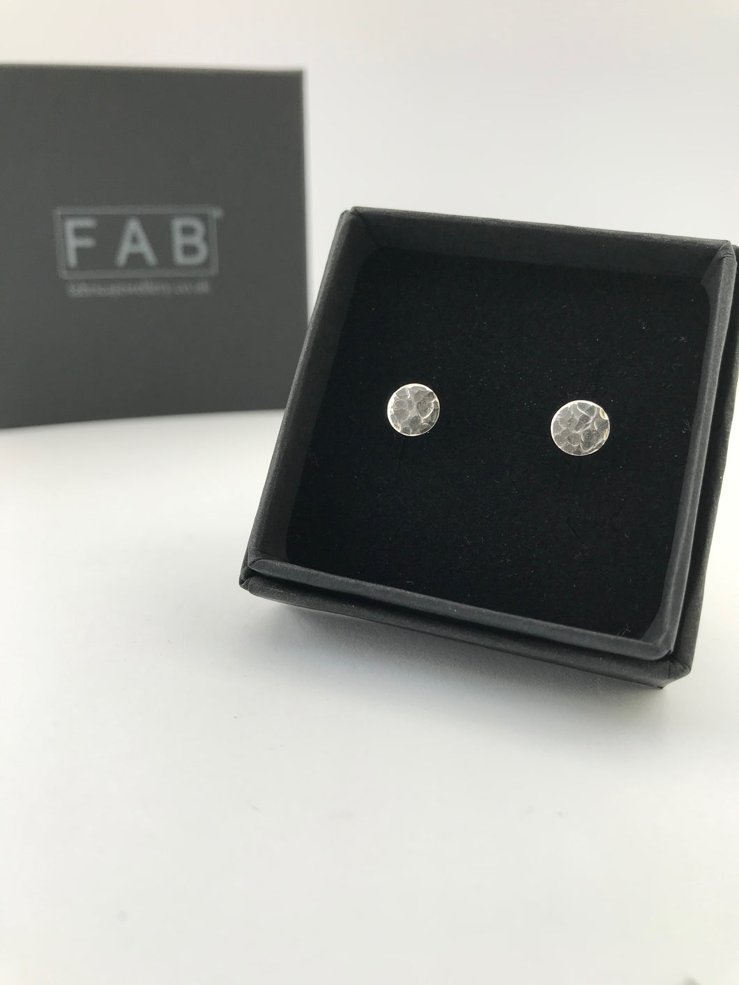 Handmade Sterling Silver Flat Round Hammered Stud Earrings, Shown Inside Black Jewellery Box. 