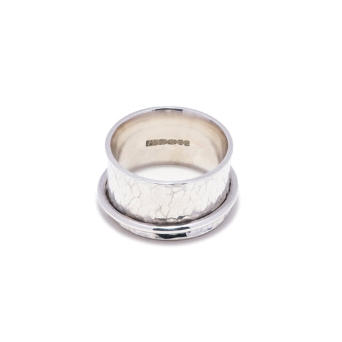 Planished hammered texture ladies spinner ring on white background showing full U.K. London Assay Office Hallmark.