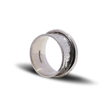 Load image into Gallery viewer, Planished hammered texture ladies spinner ring standing on edge displayed on white background showing full U.K. London Assay Office Hallmark.