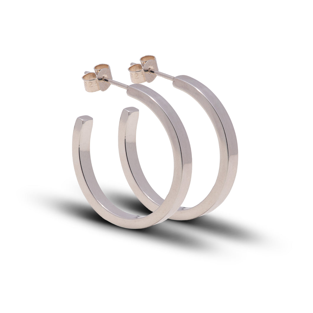 Square Sterling Silver Wire Hoop Earrings Stood Up Together Against Bright White Background.